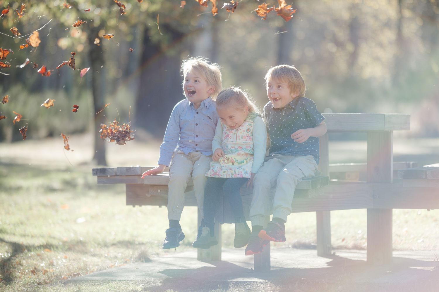 children laughing in family photo during Autumn at squirrel lake, North Canterbury