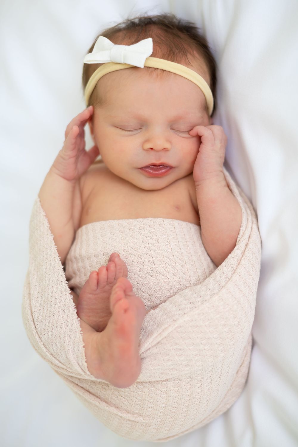 Newborn girl sleeping on white bed swaddled at Prospect Farms studio near Athens, GA - Ansley Howe Photography