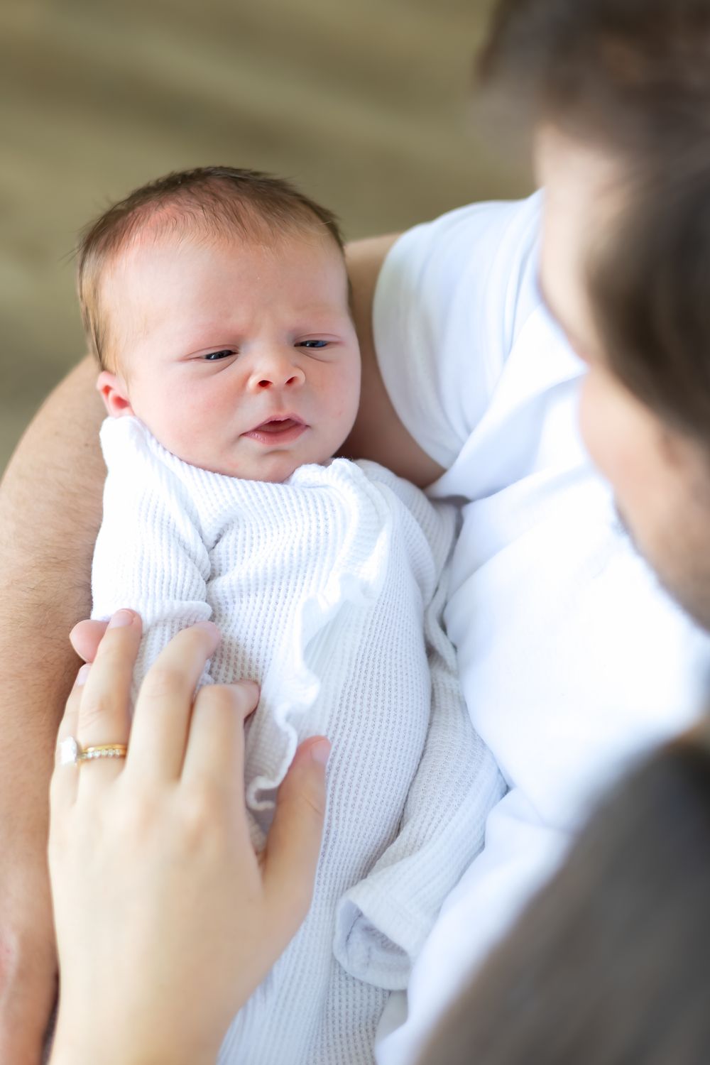 Close-up of newborn baby girl sleeping peacefully wrapped in white swaddle during Prospect Farms session
