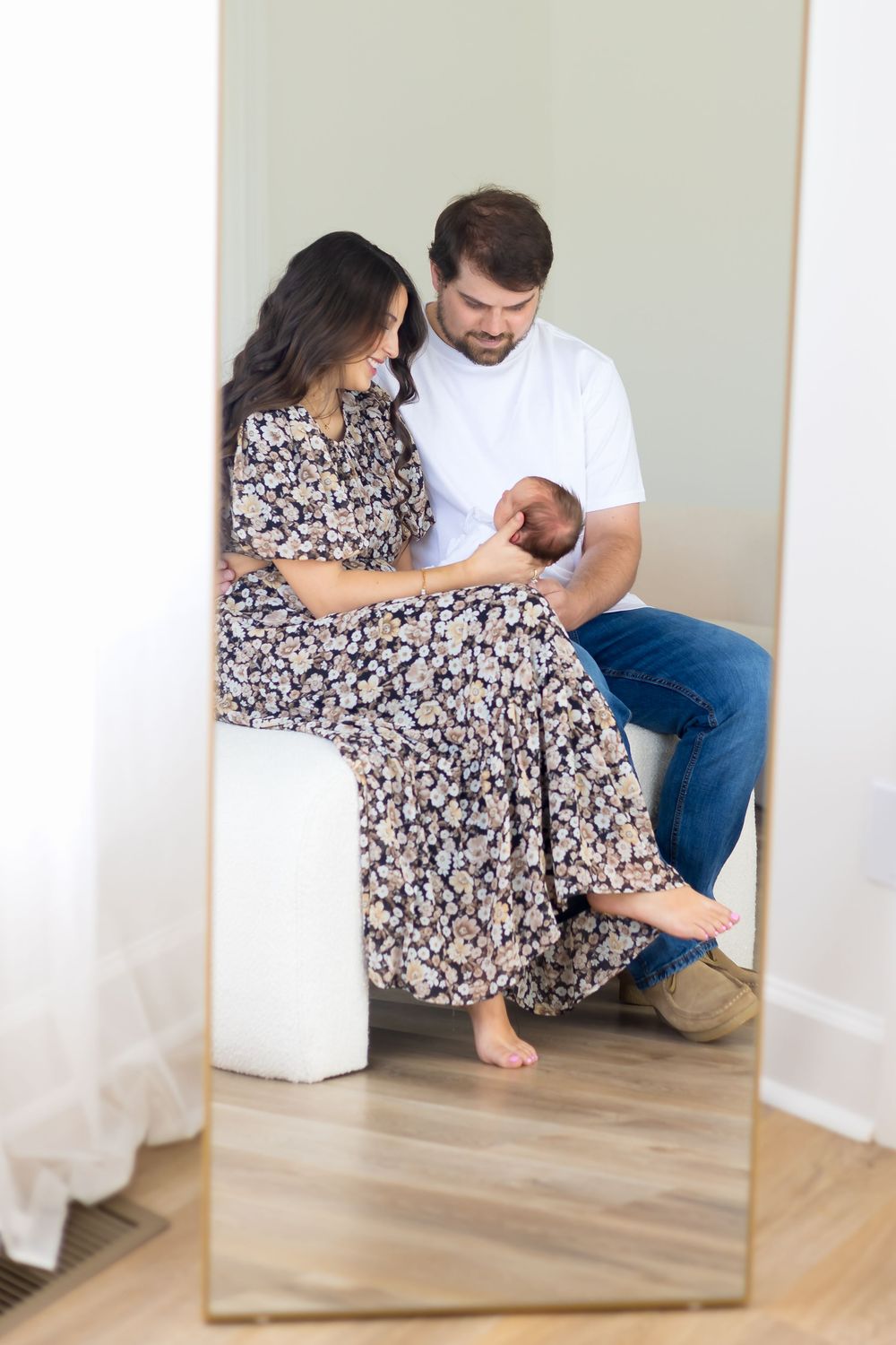 Lifestyle newborn photography in Northeast Georgia with mom, dad, and baby girl in soft, neutral tones