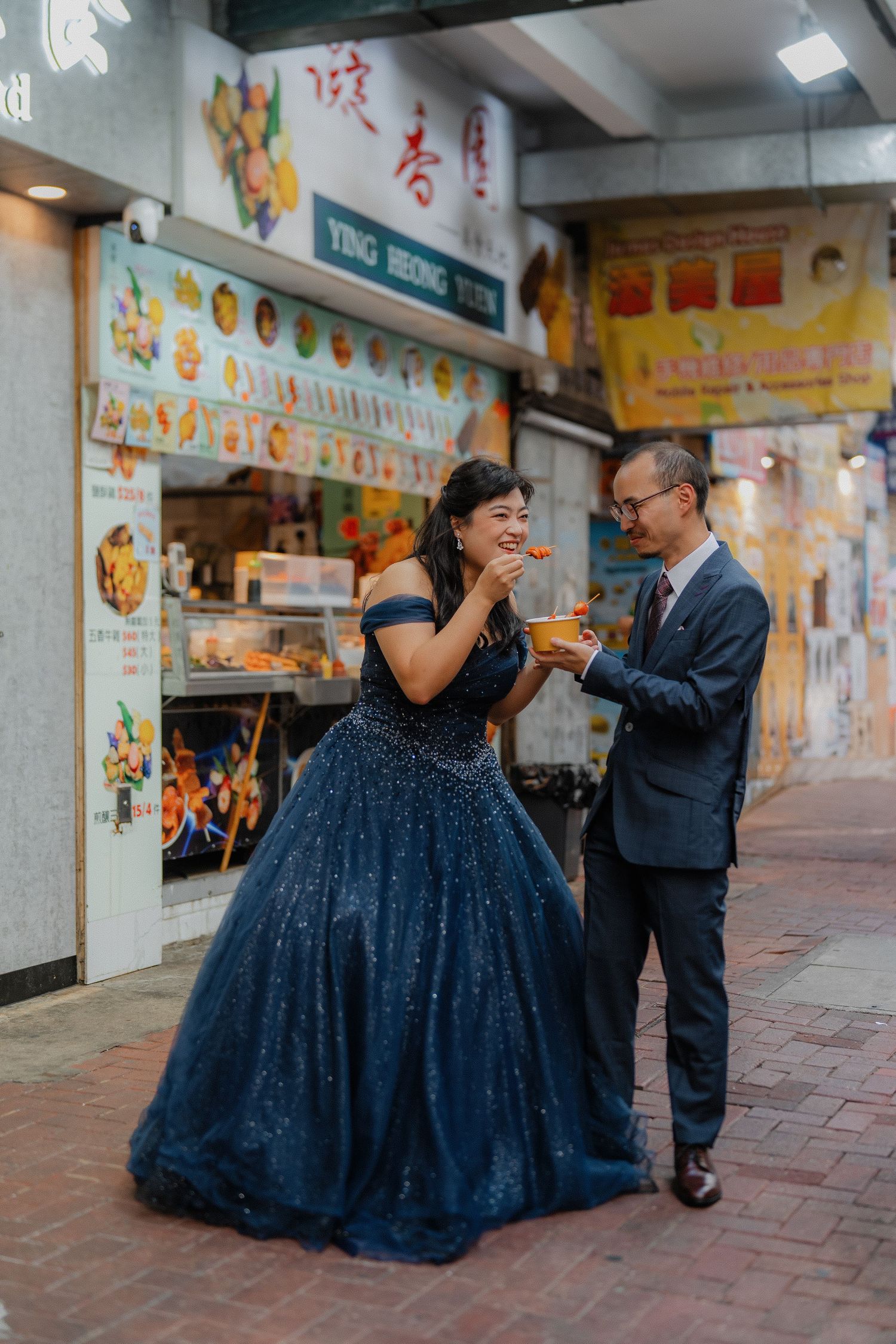 Joyful moment shared over street food at a local Hong Kong food stall.