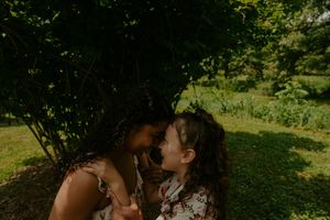 A peaceful scene of people enjoying nature in a lush green field.