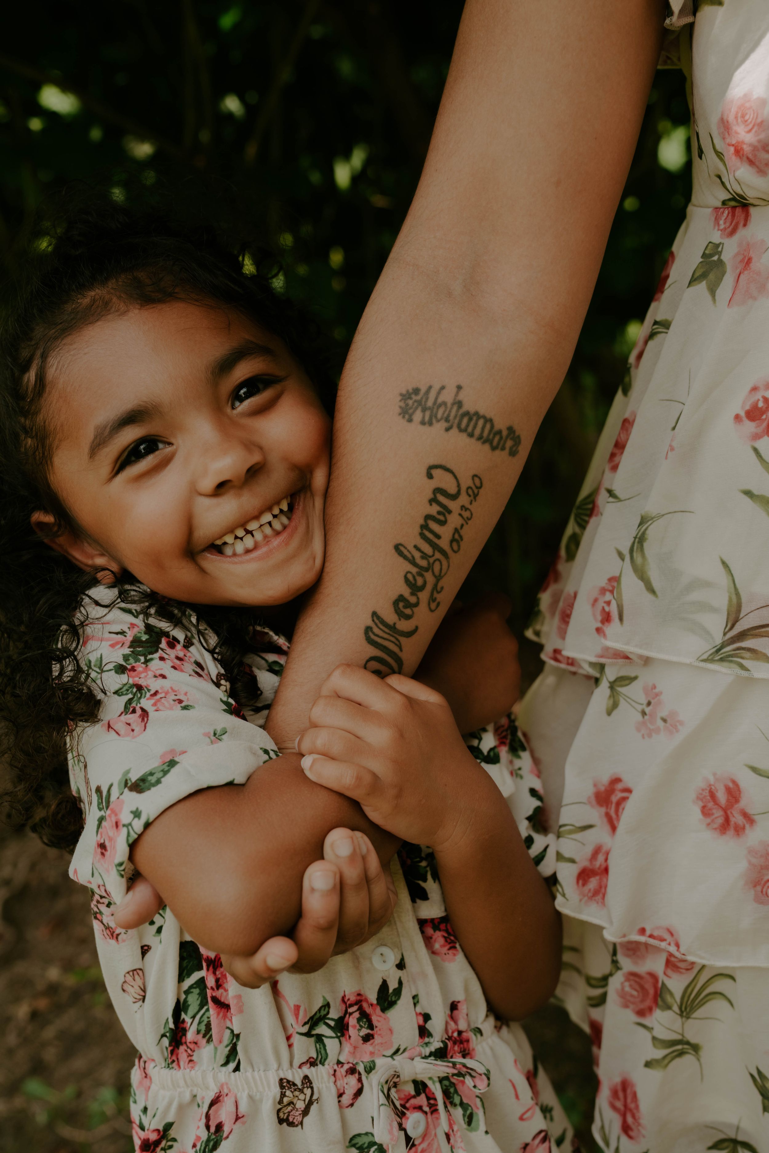 Close-up shots showing joyful expressions and floral dress details in natural lighting.