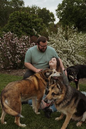Candid moments captured with German Shepherds and other dogs during an outdoor photo session.