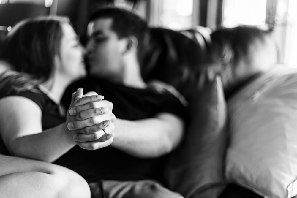 Two hands reach toward each other in black and white, creating an artistic composition of connection and longing.