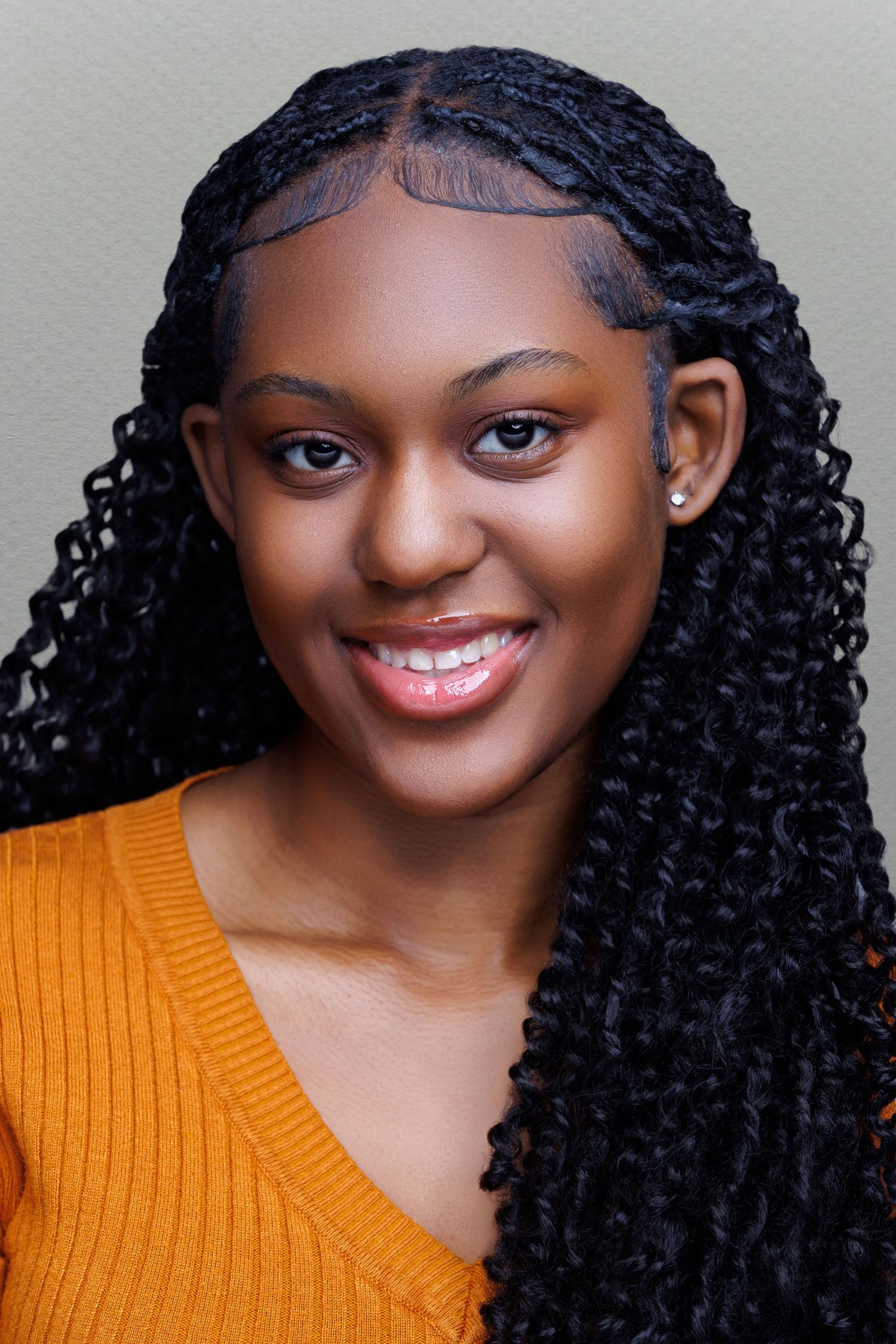 Professional headshot of a smiling woman with shoulder-length brown hair, wearing a blue blouse against a neutral background.
