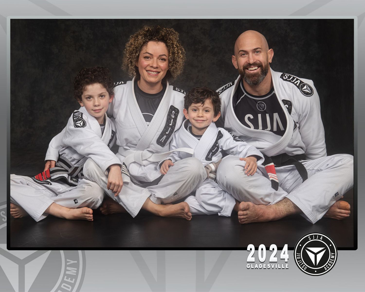 Family group portrait in white martial arts uniforms.