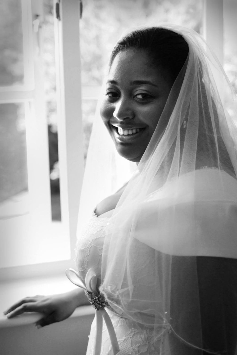 Delicate white bridal veil flowing in soft natural light creating an ethereal effect.