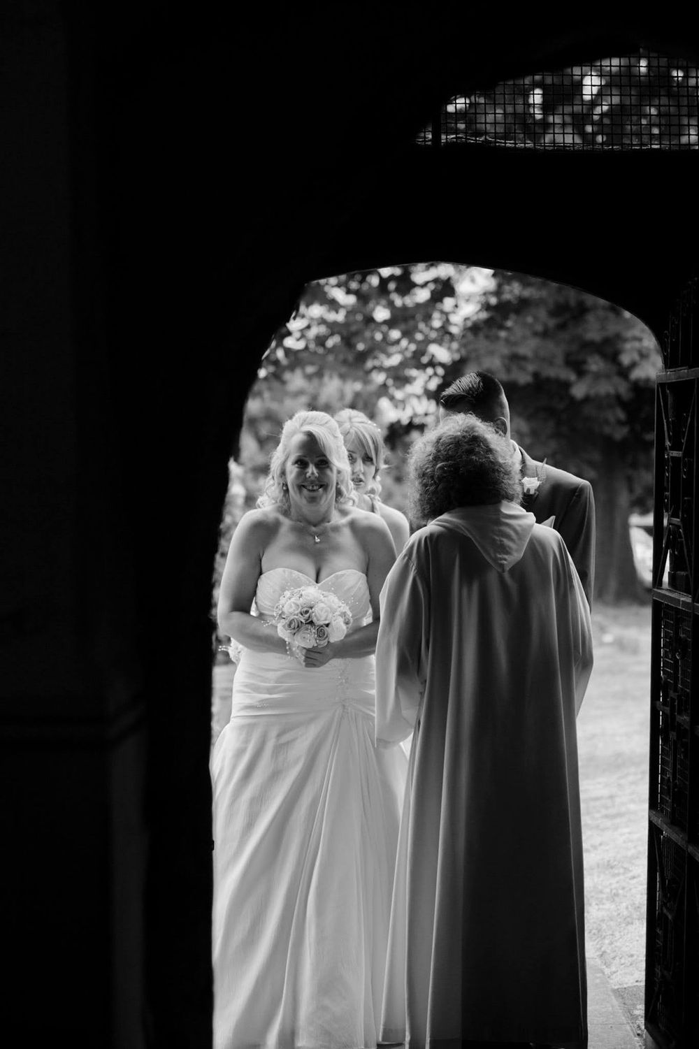 Wedding party walking together outdoors in formal attire with flowing dresses.