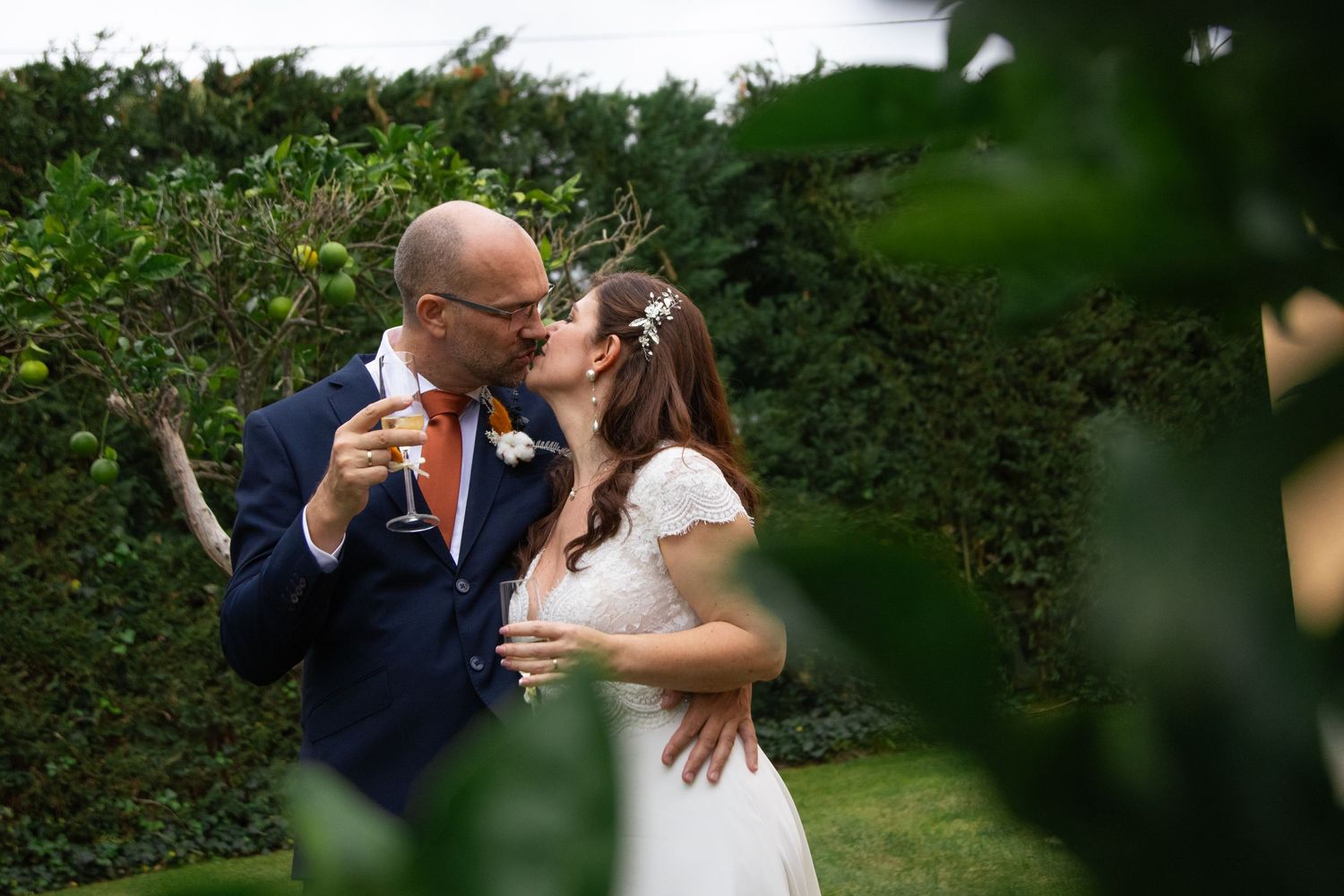 Intimate wedding portraits captured in a lush garden setting.
