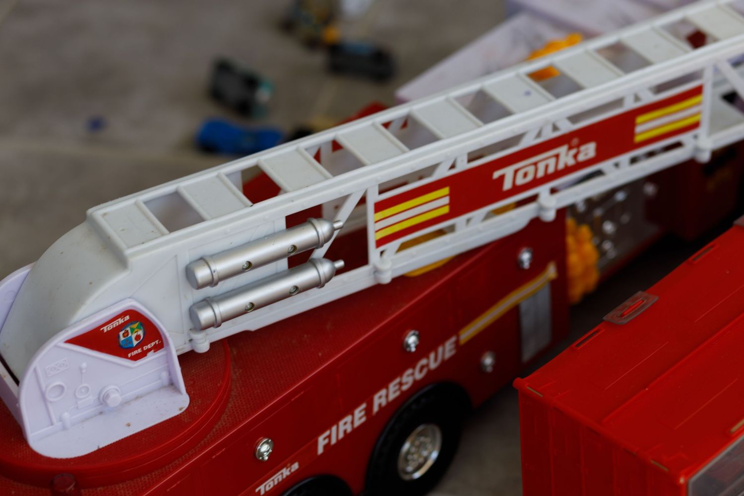 Red and white Tonka fire truck toy with ladder detail.