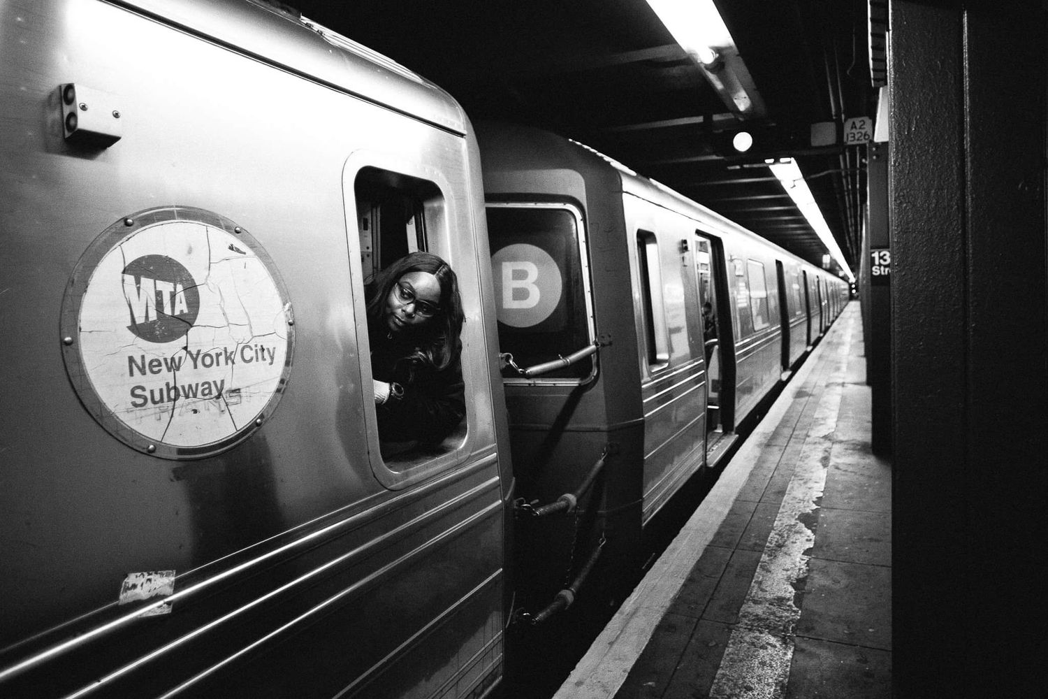 Vintage black and white photo of a New York City subway train at a station platform.