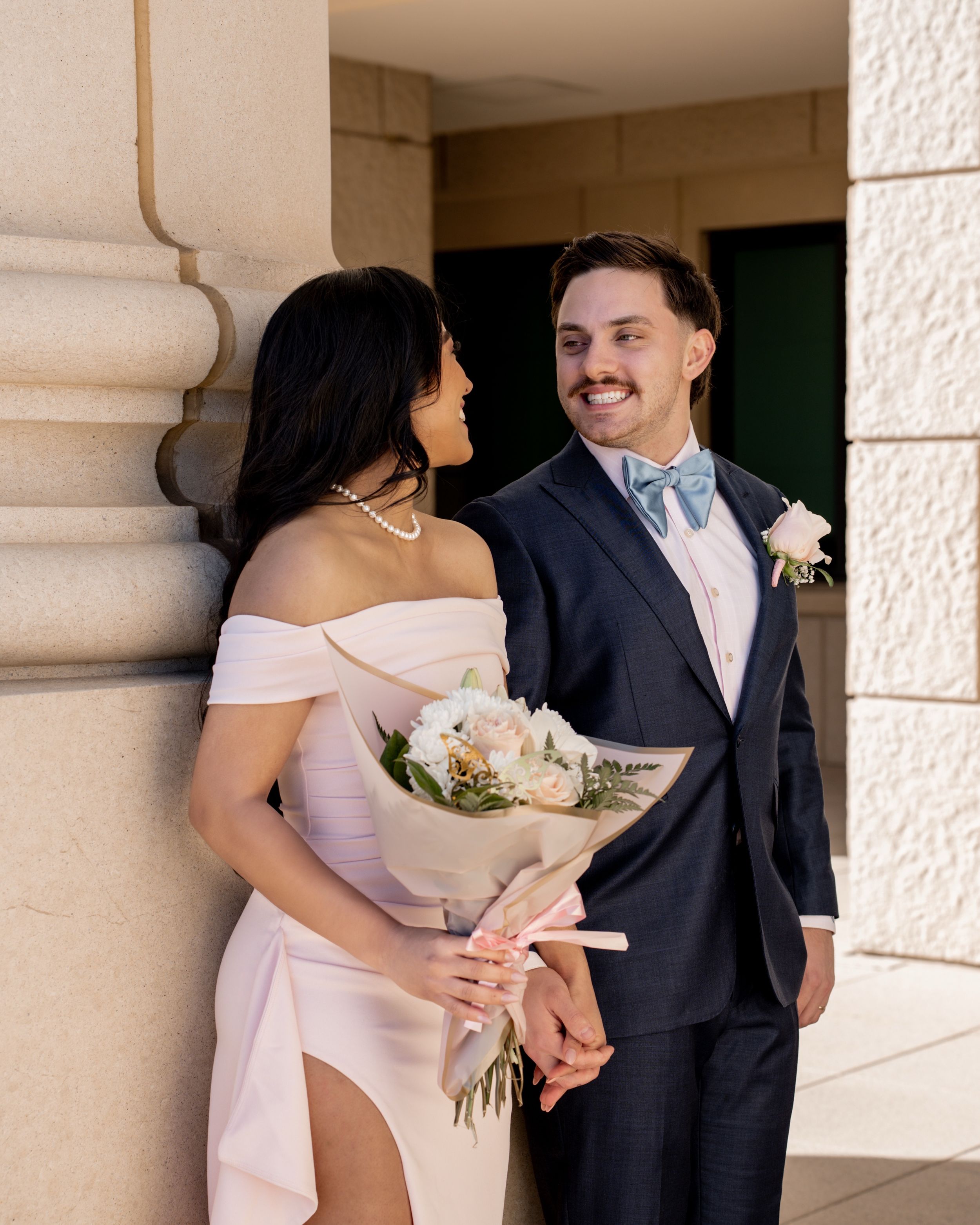 Romantic wedding portrait outside stone arches — luxury photography in Denton, Texas.