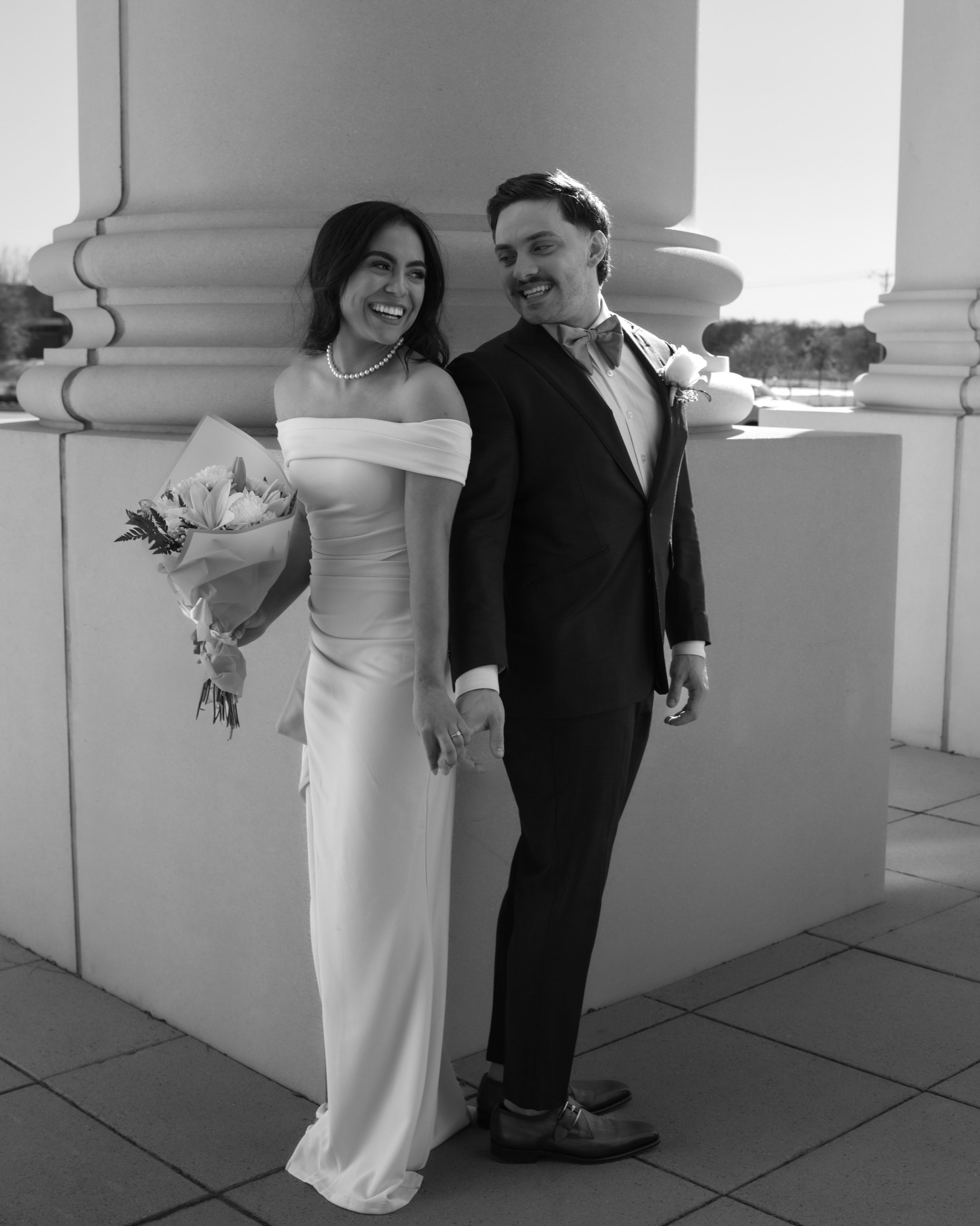 Elegant black and white wedding photo of a couple on a balcony — timeless photography in Denton, Texas.