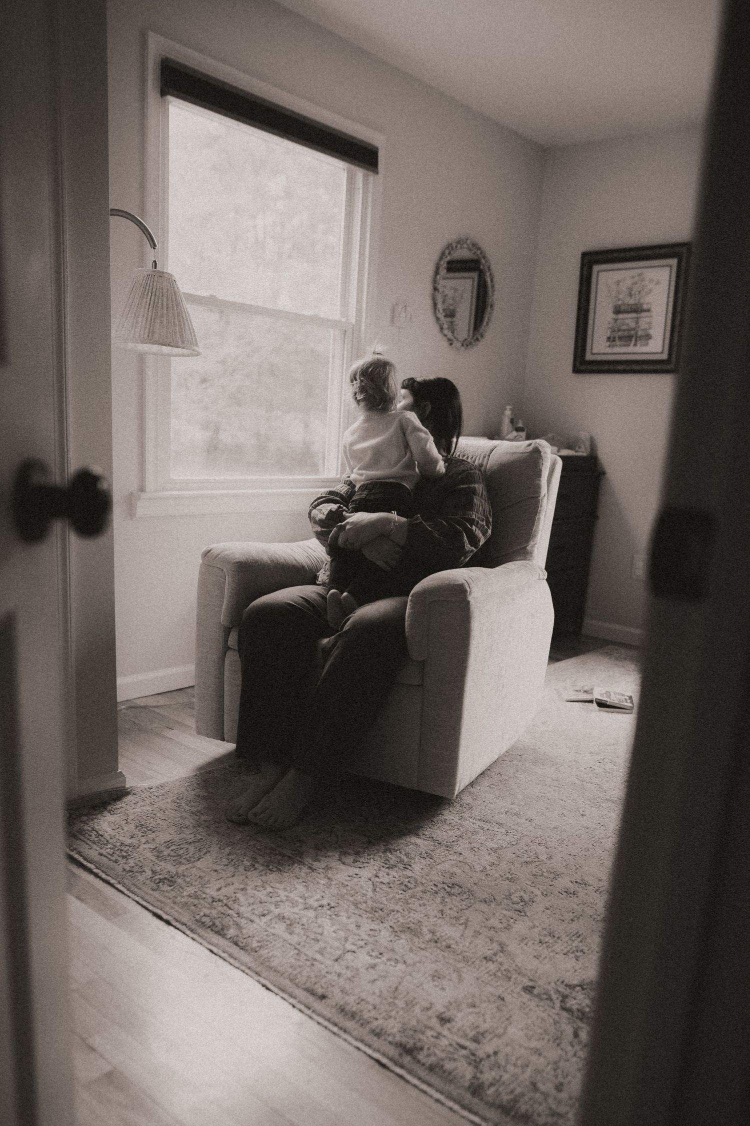 A black and white photo series showing a figure in a chair by a window, creating a moody atmospheric sequence.