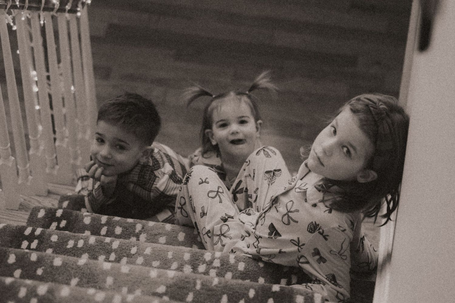 Children sit at a table with birthday candles and cake during a celebration party.