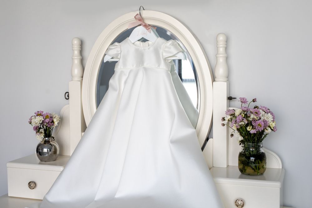 christening dress handing on dresser