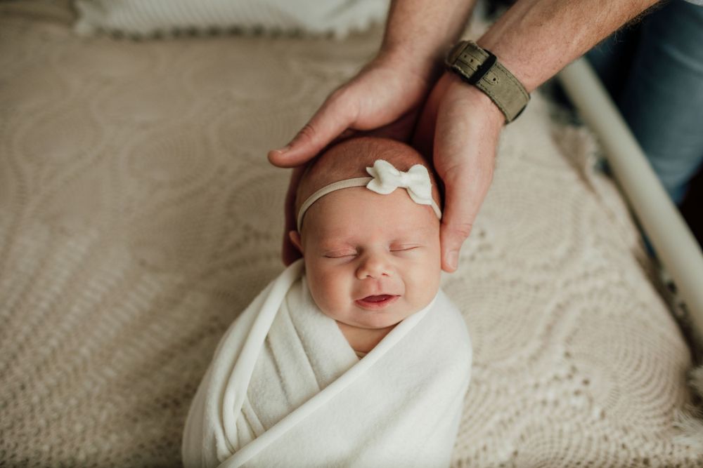 Close-up newborn photography session capturing sweet details and wrapping.