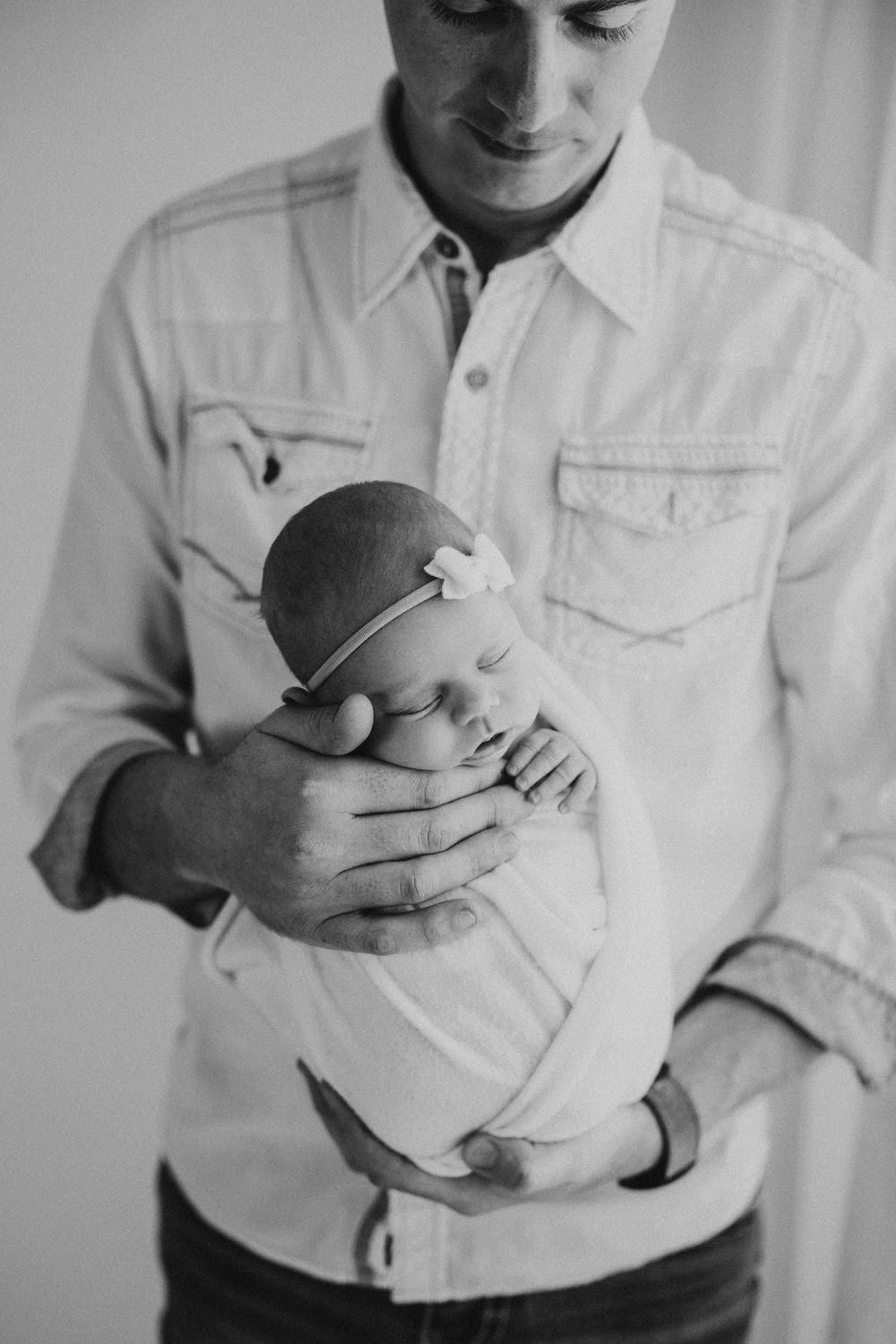 Black and white series showing gentle moments with newborn baby.