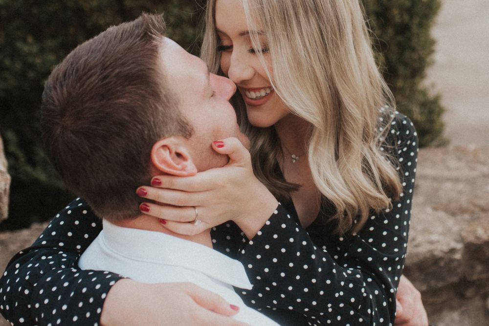 An intimate close-up portrait of a couple sharing a romantic moment outdoors.
