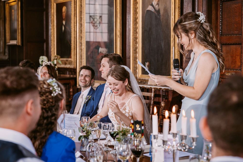 Wedding speeches elicit emotional reactions during an elegant dining reception in a historic hall at Balliol College, Oxford
