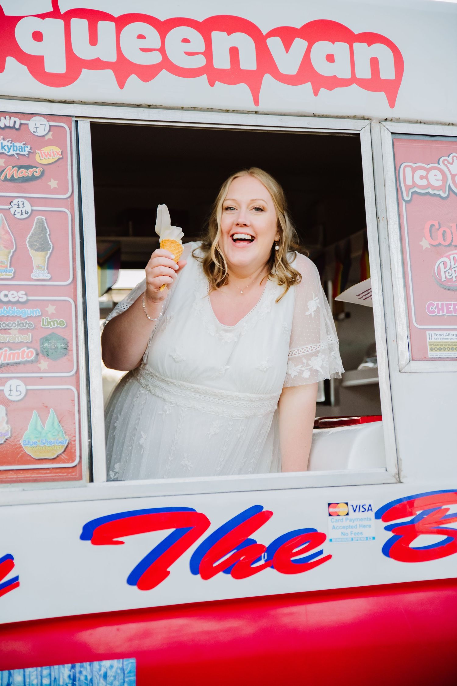 A bride is in an icecream van in a wedding dress on her wedding day. Icecreams van hire for Weddings Wiltshire