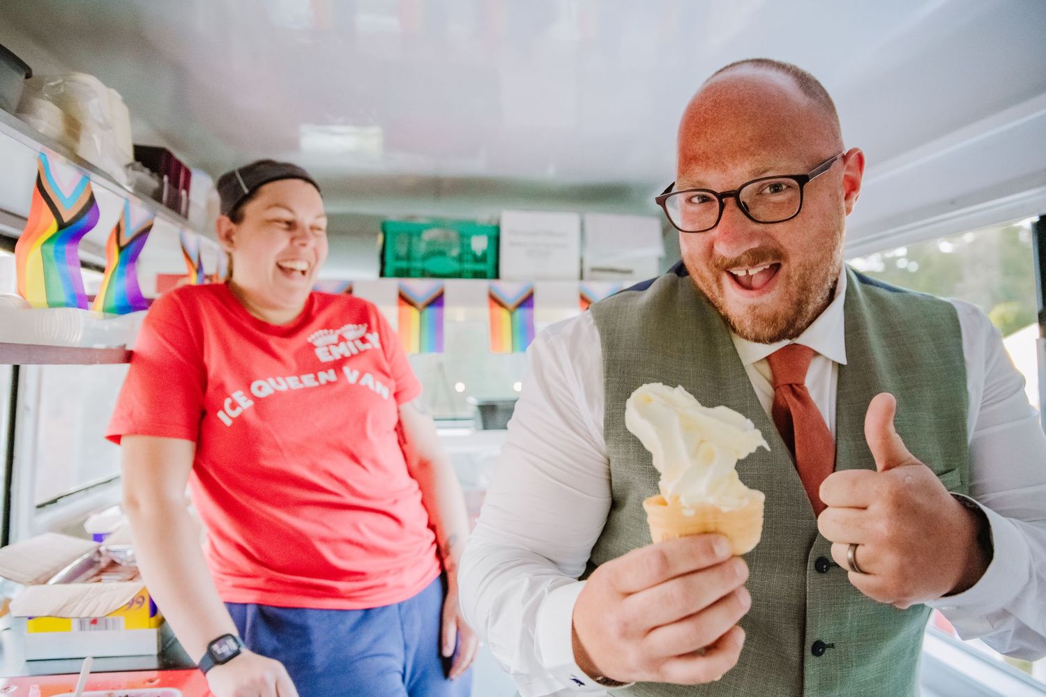 A groom is in an ice cream van on his wedding day after making his own 99 mr whippy ice cream. He has his thumb up and is smiling