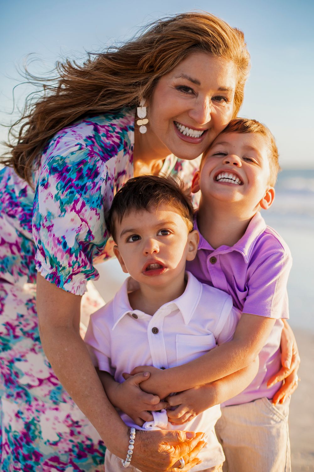grandmother with grandchildren on st. pete beach grandparents photoshoot in tampa bay