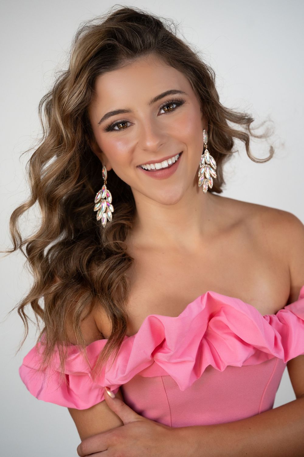 A series of glamour shots showing someone in a pink off-shoulder ruffled top against a light background.
