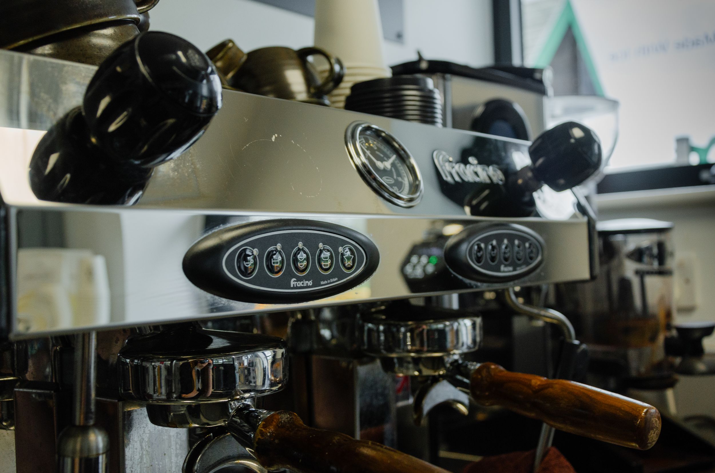 Professional espresso machine with chrome finish and multiple group heads.