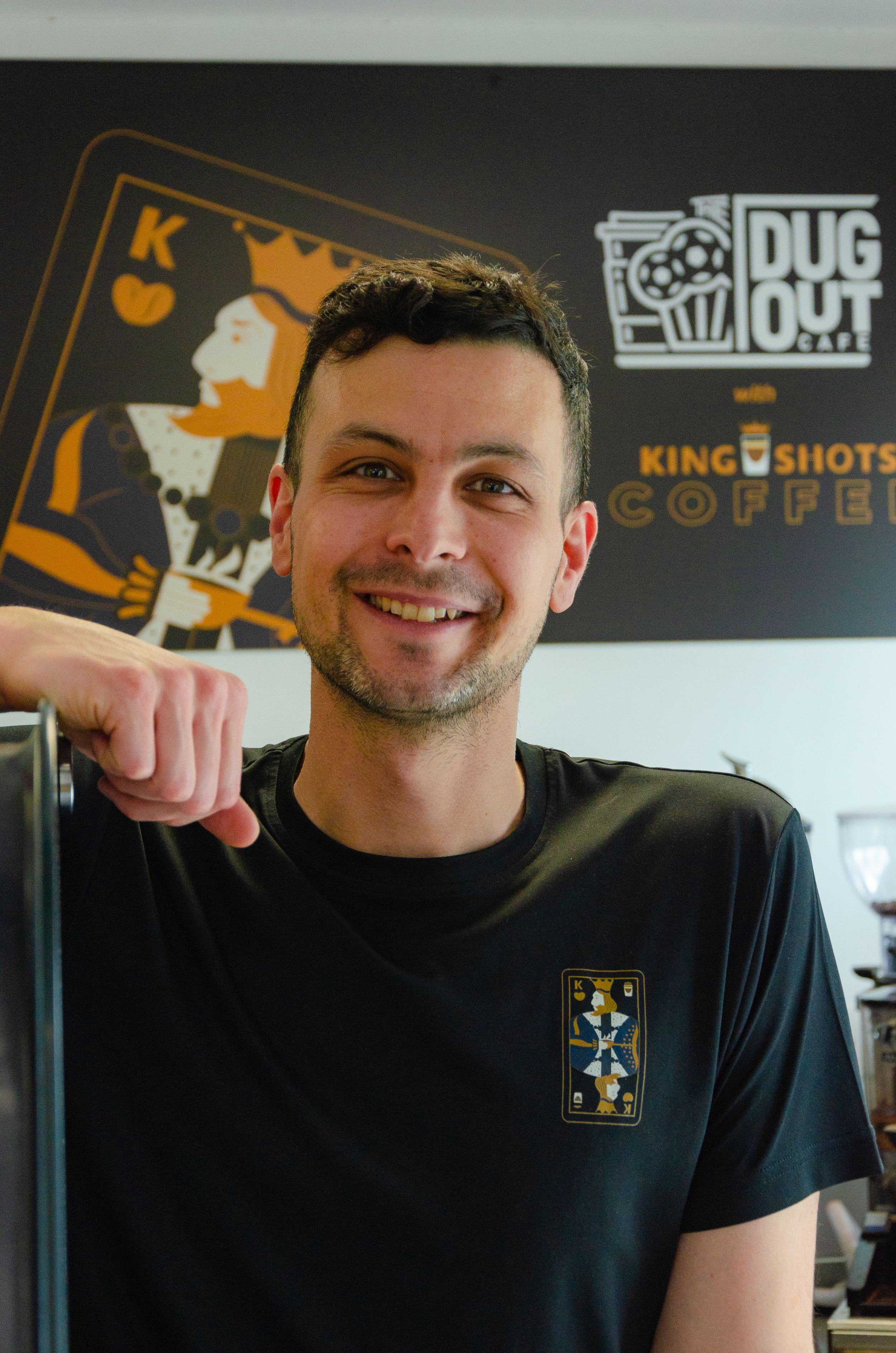 Coffee shop interior with King Shots Coffee branding on wall.