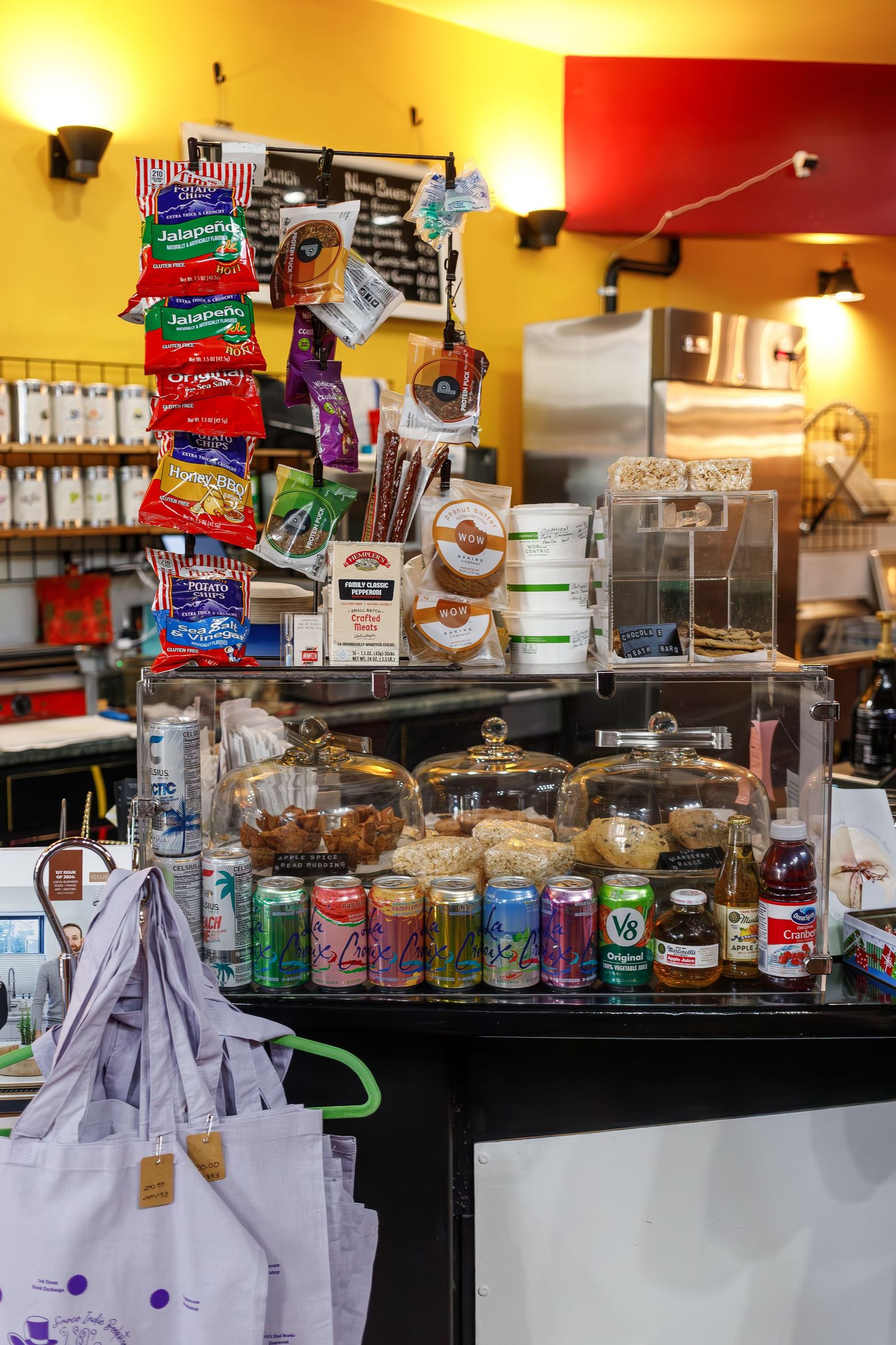 Display case filled with snacks, drinks and retail items at a bookstore cafe.