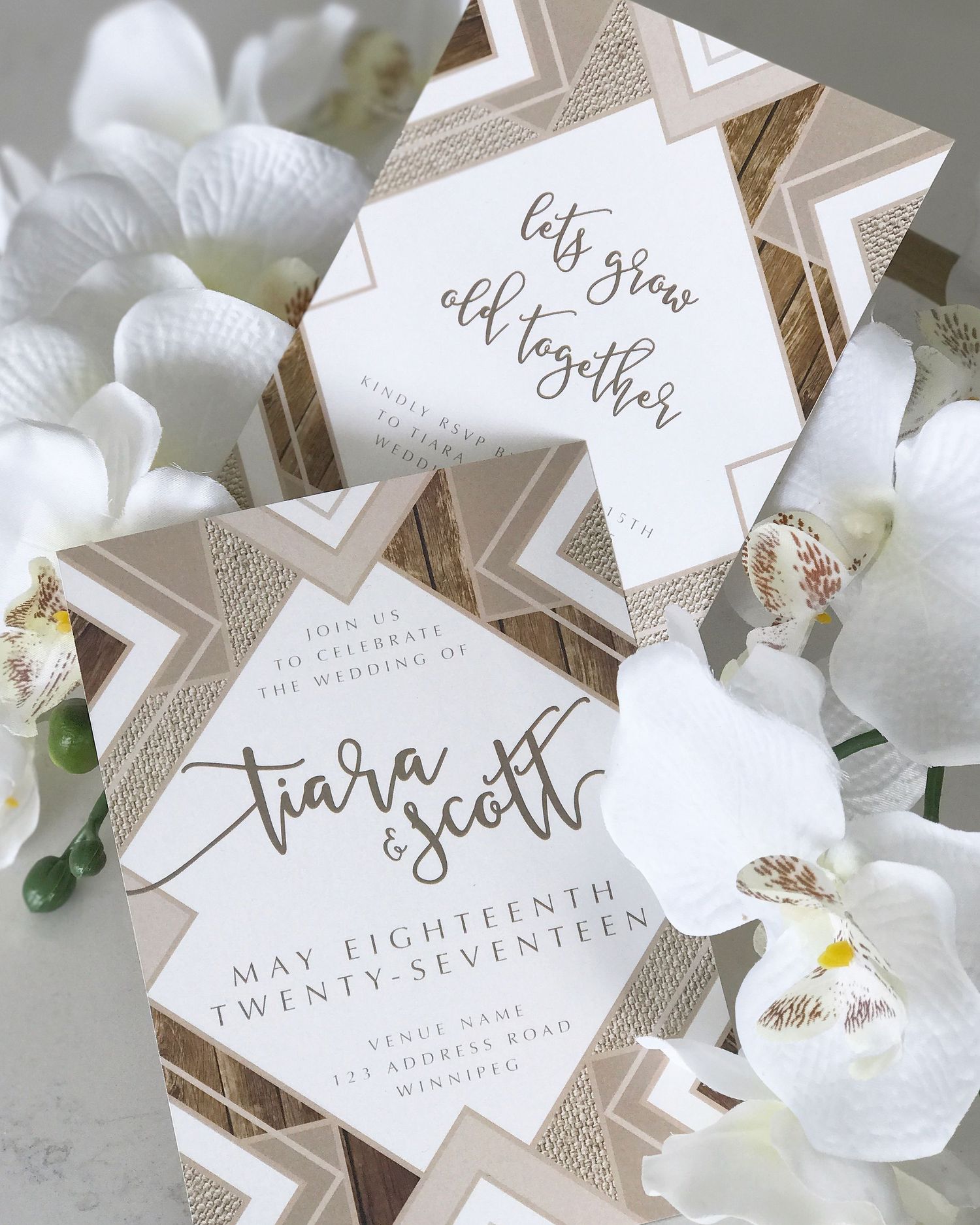Elegant wedding invitation with geometric patterns and white orchids in a flat lay composition.