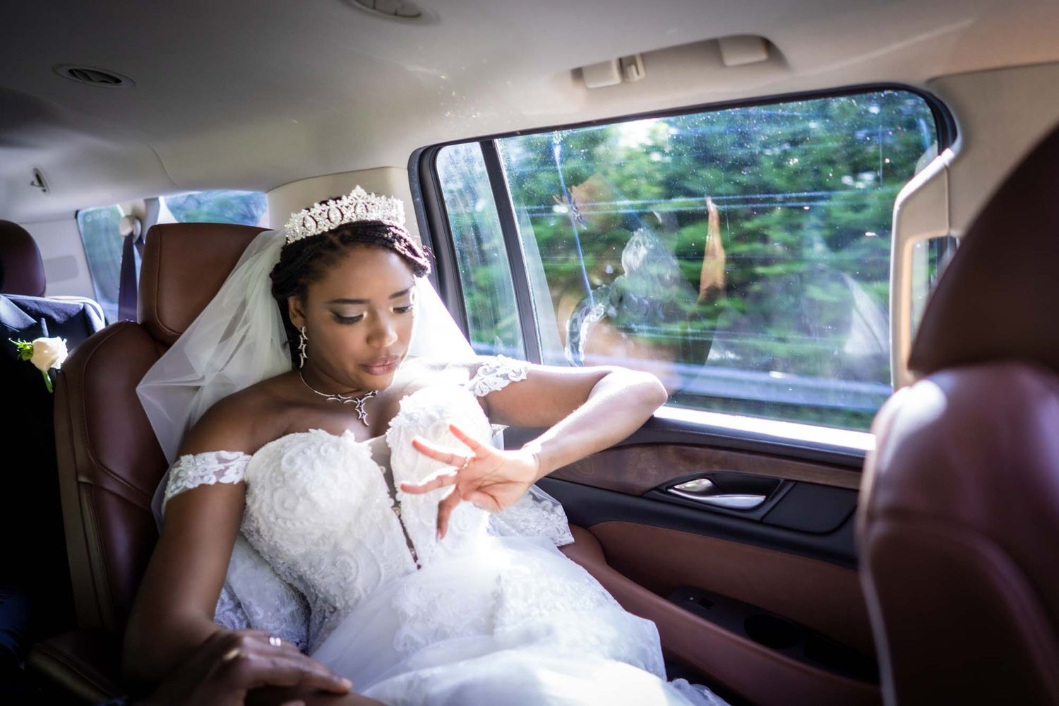 Bride lost in thought, gazing at her wedding ring, St. John's, Newfoundland.