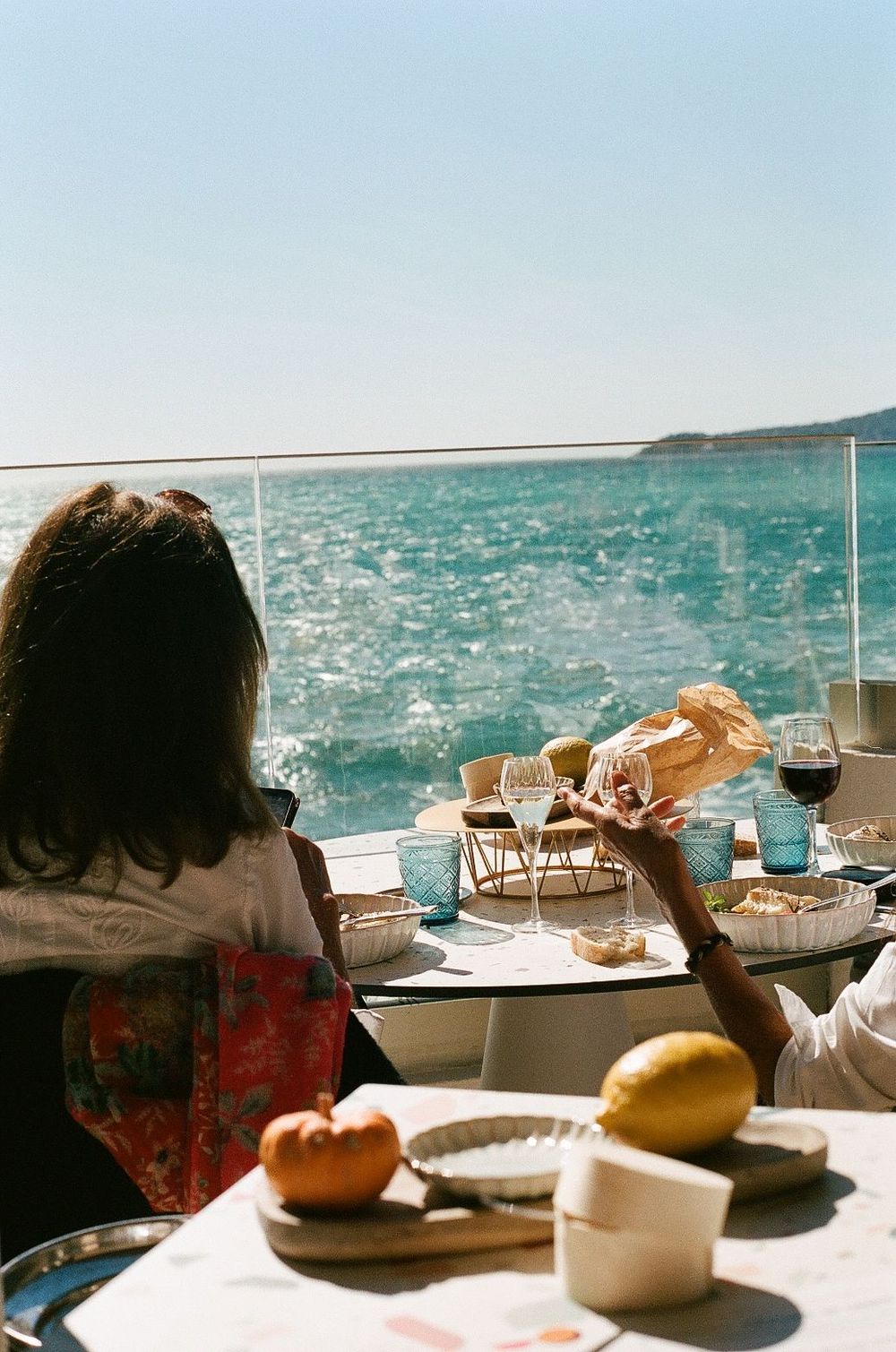 Diners enjoy a scenic ocean view meal on a boat or waterfront restaurant.