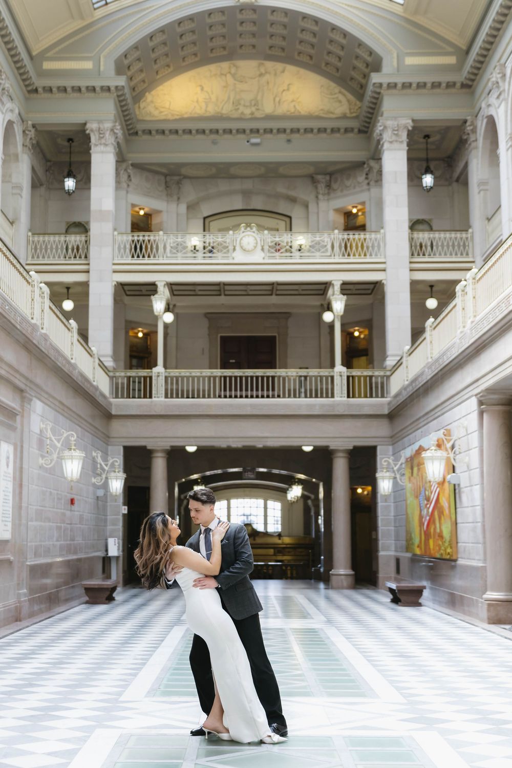 A romantic dance sequence in a grand marble hall with checkered floors and ornate architecture.