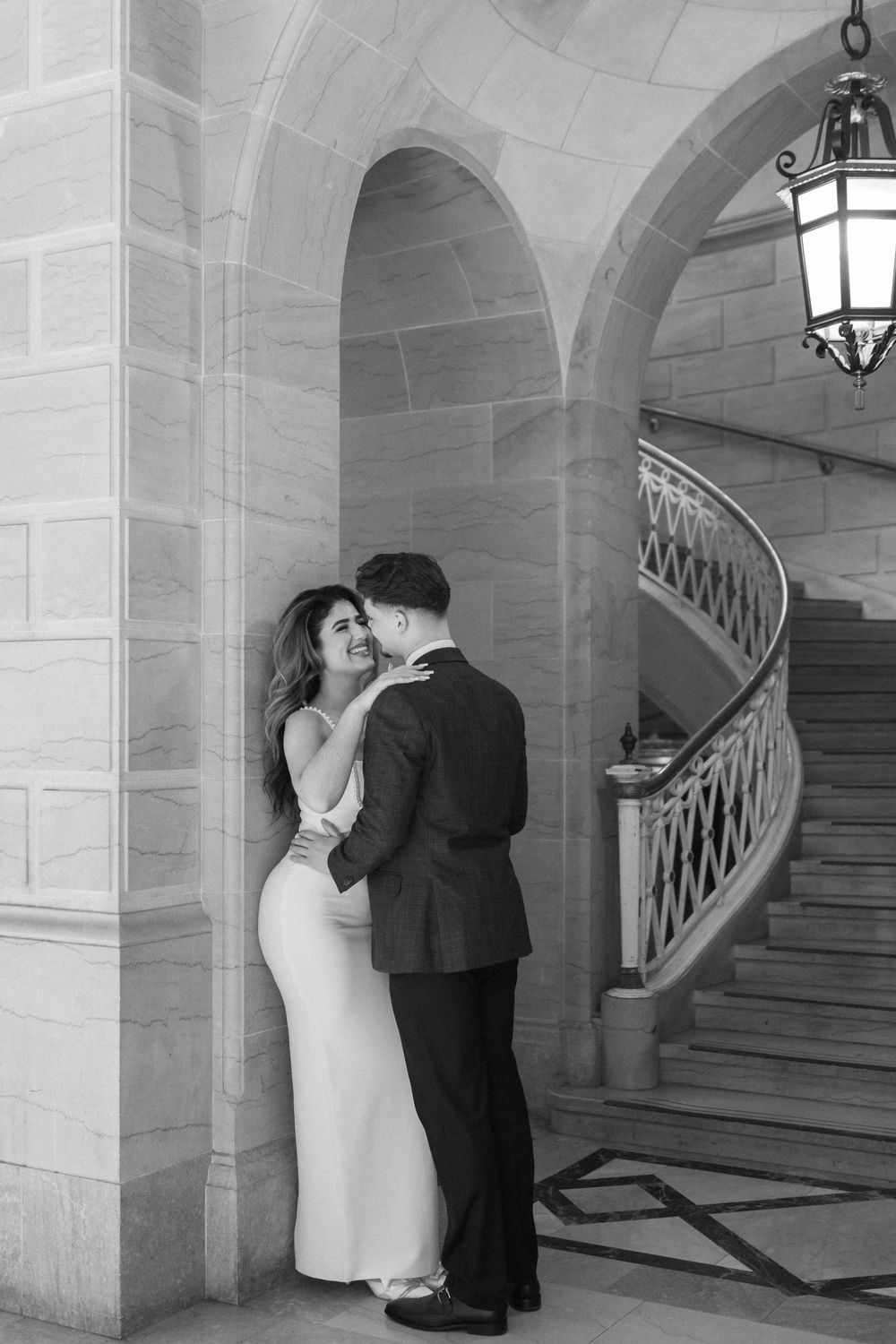 Intimate wedding photos taken in a historic building with beautiful architectural details.