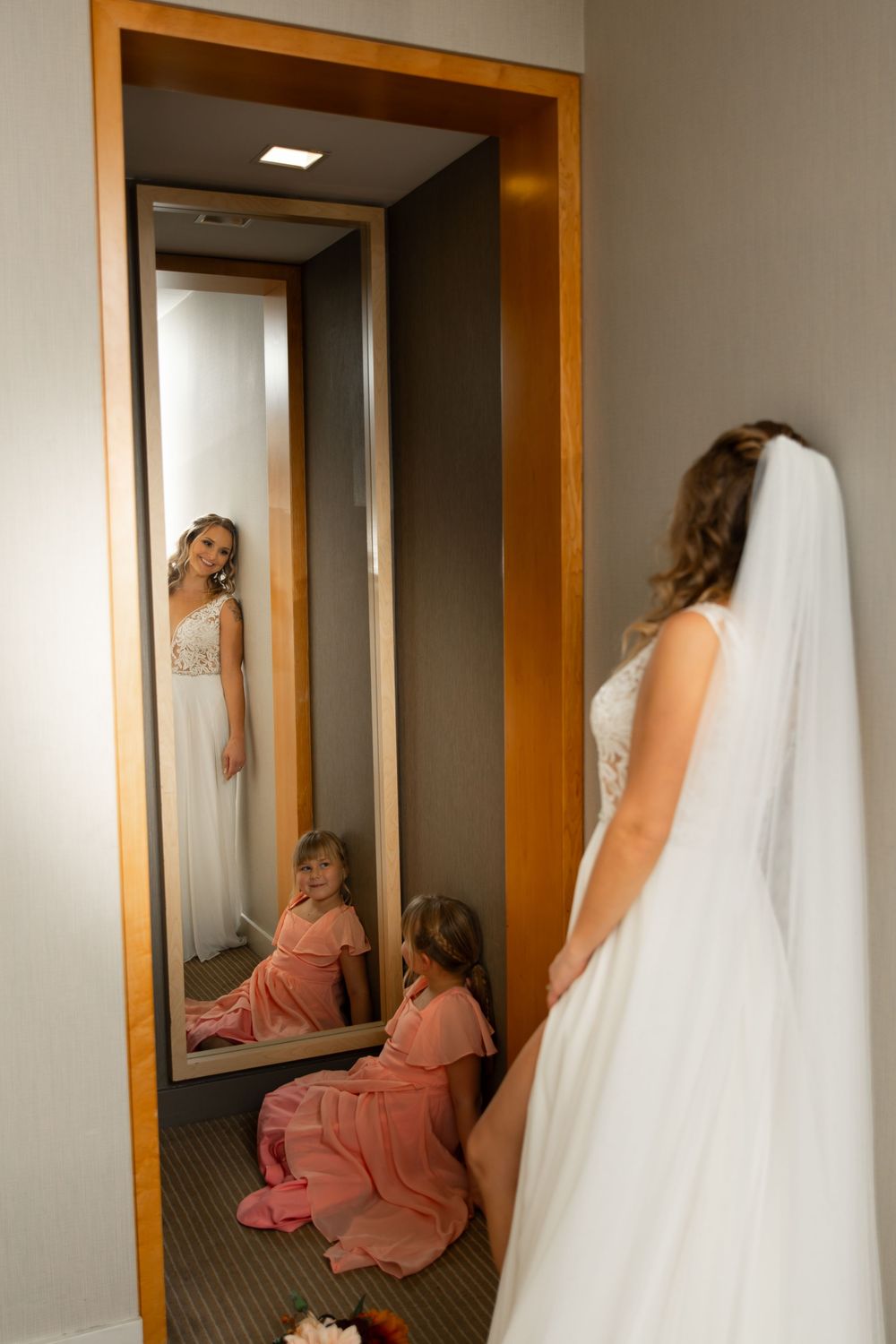 A sequence of photos showing someone in a wedding dress and bridesmaid in coral dress peeking around hotel hallway corners.