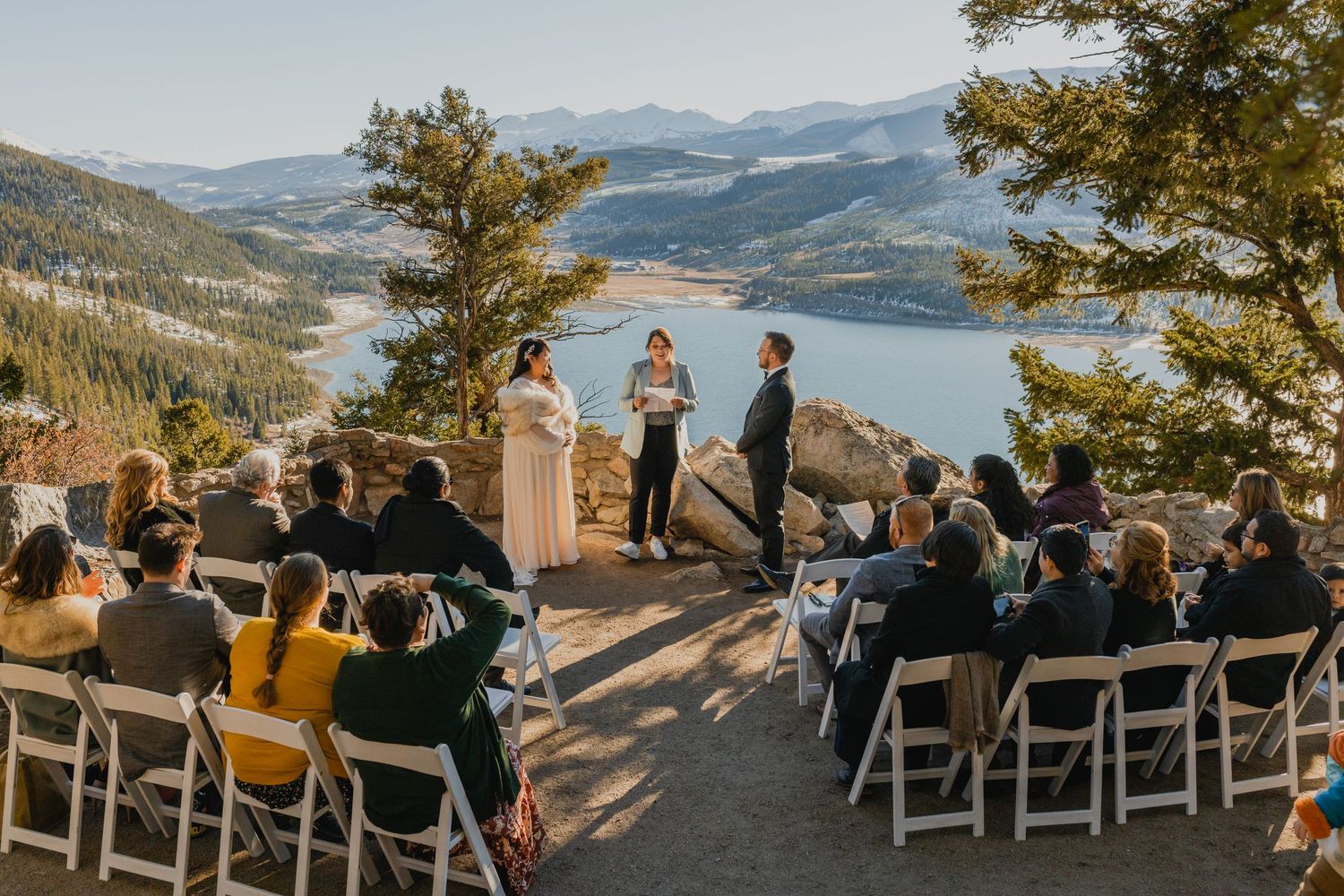 Newlyweds embrace with snow-capped mountains in the background, a perfect Breckenridge elopement moment.