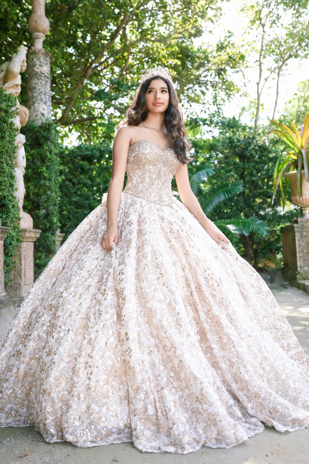 Stunning champagne ballgown with sequins photographed in garden setting.