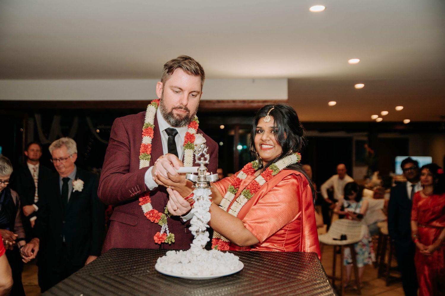 A couple cuts their wedding cake together during the reception celebration.