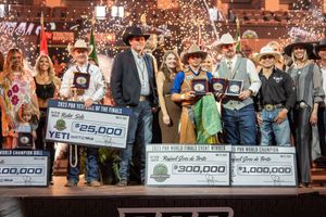 Group celebrates with prize checks and awards at rodeo championship ceremony.