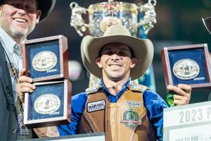 Winners display their prize buckles and awards at rodeo championship ceremony.