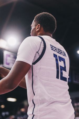 Close-up of basketball players' jerseys with numbers during a game.
