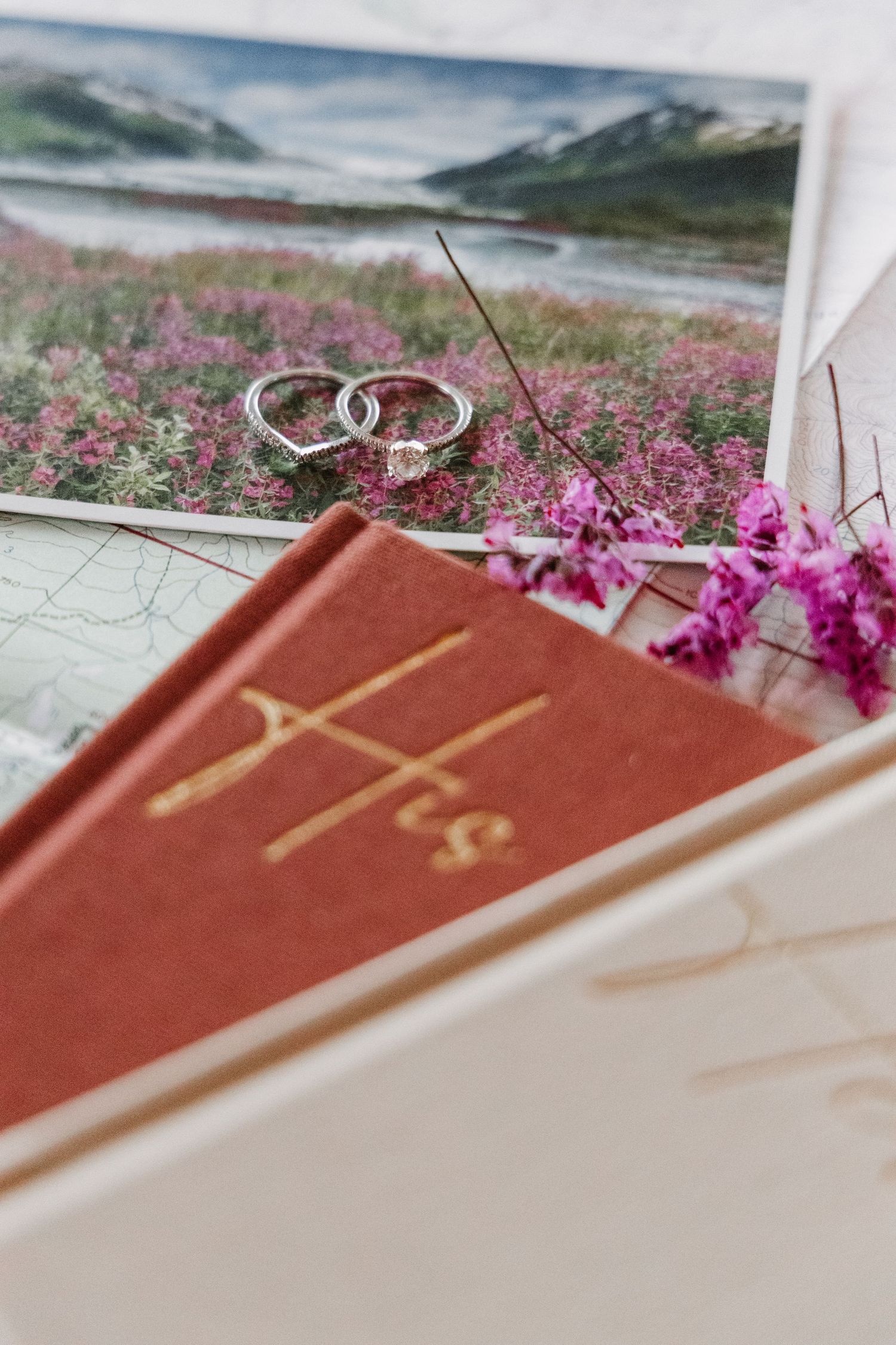 detail shot featuring a beautiful ring, Wyoming map and vow books
