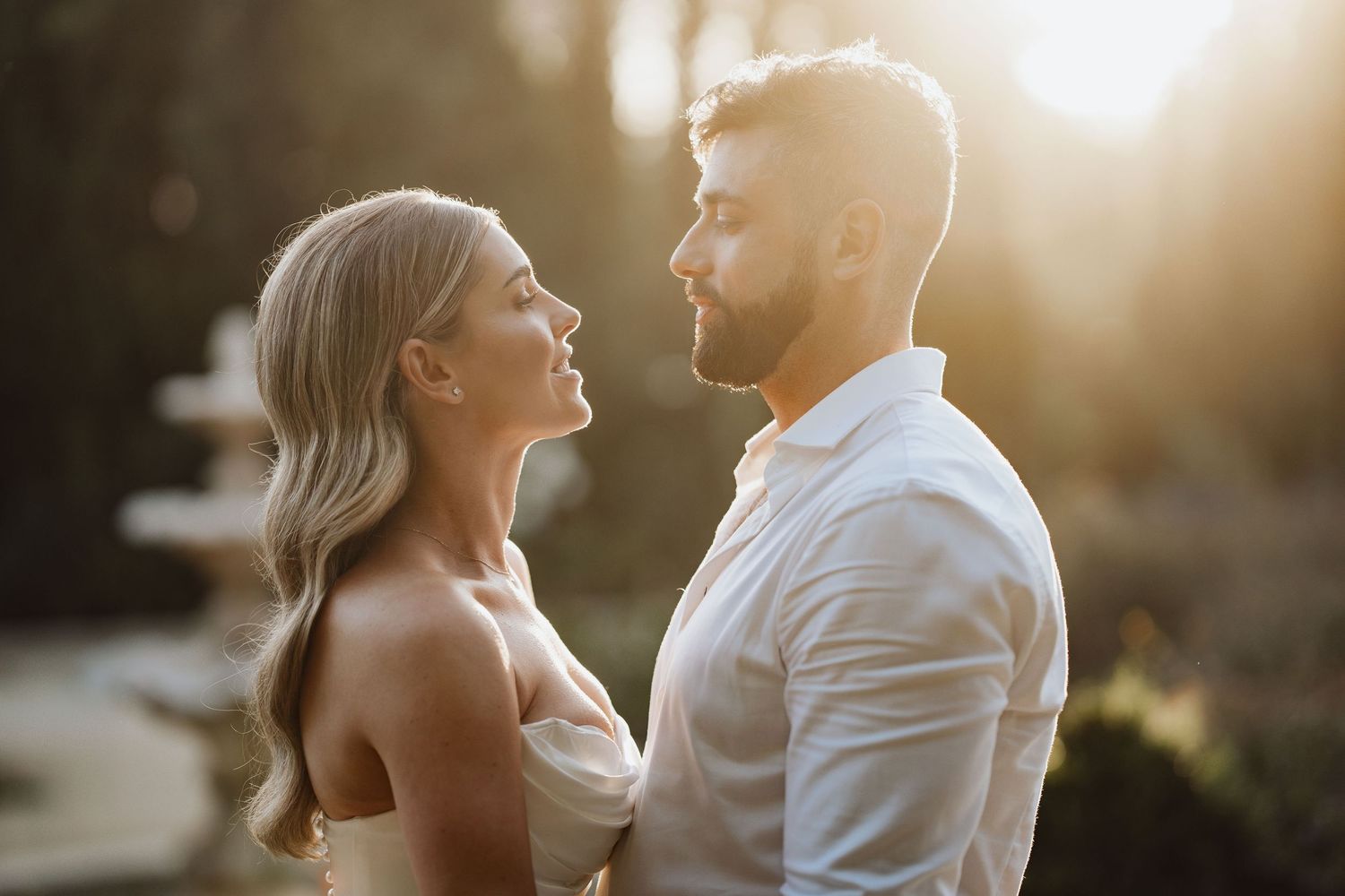 Bride and groom look into each other's eyes with the sunset behind at Finca Monastario