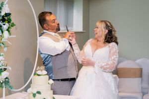 Bride and groom cut their elegant wedding cake