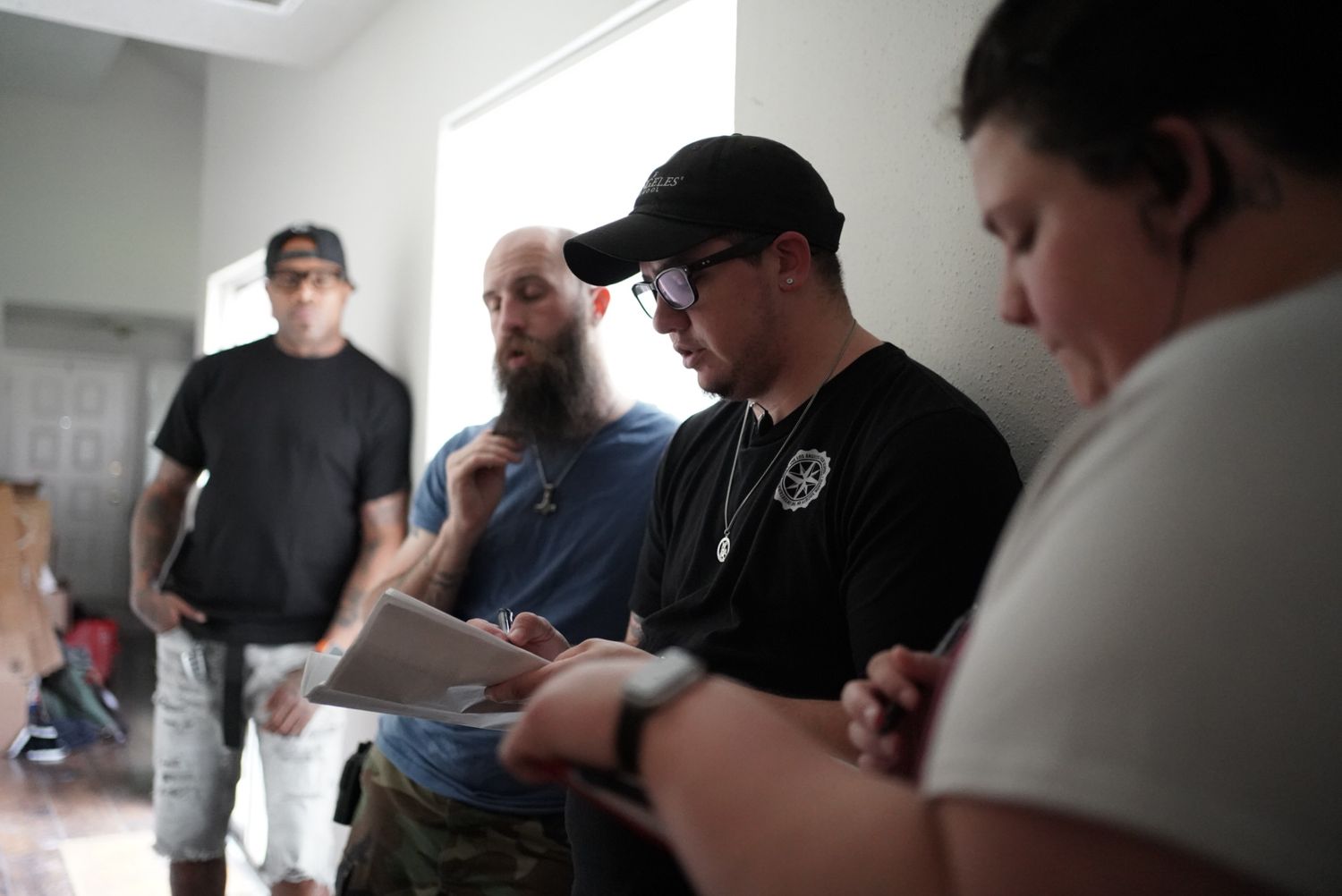 Production crew reviewing documents together during film shoot.
