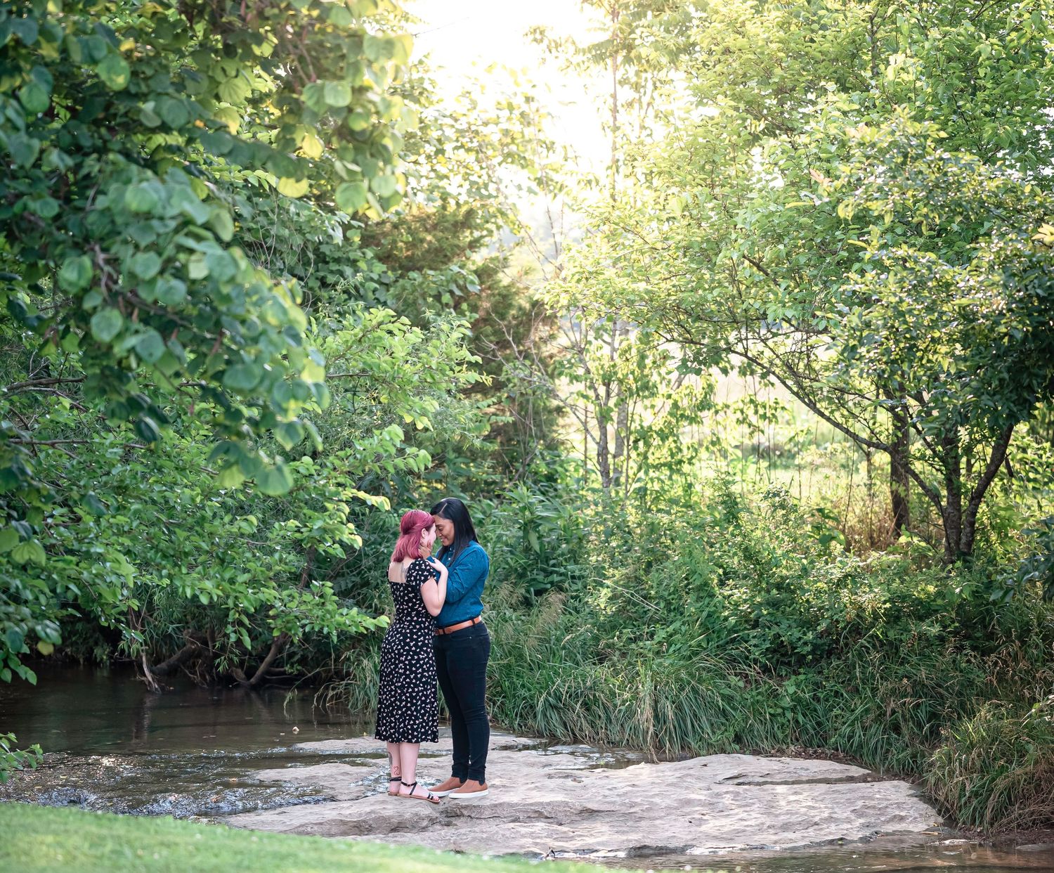 A scenic outdoor photoshoot location with winding dirt path through green foliage.