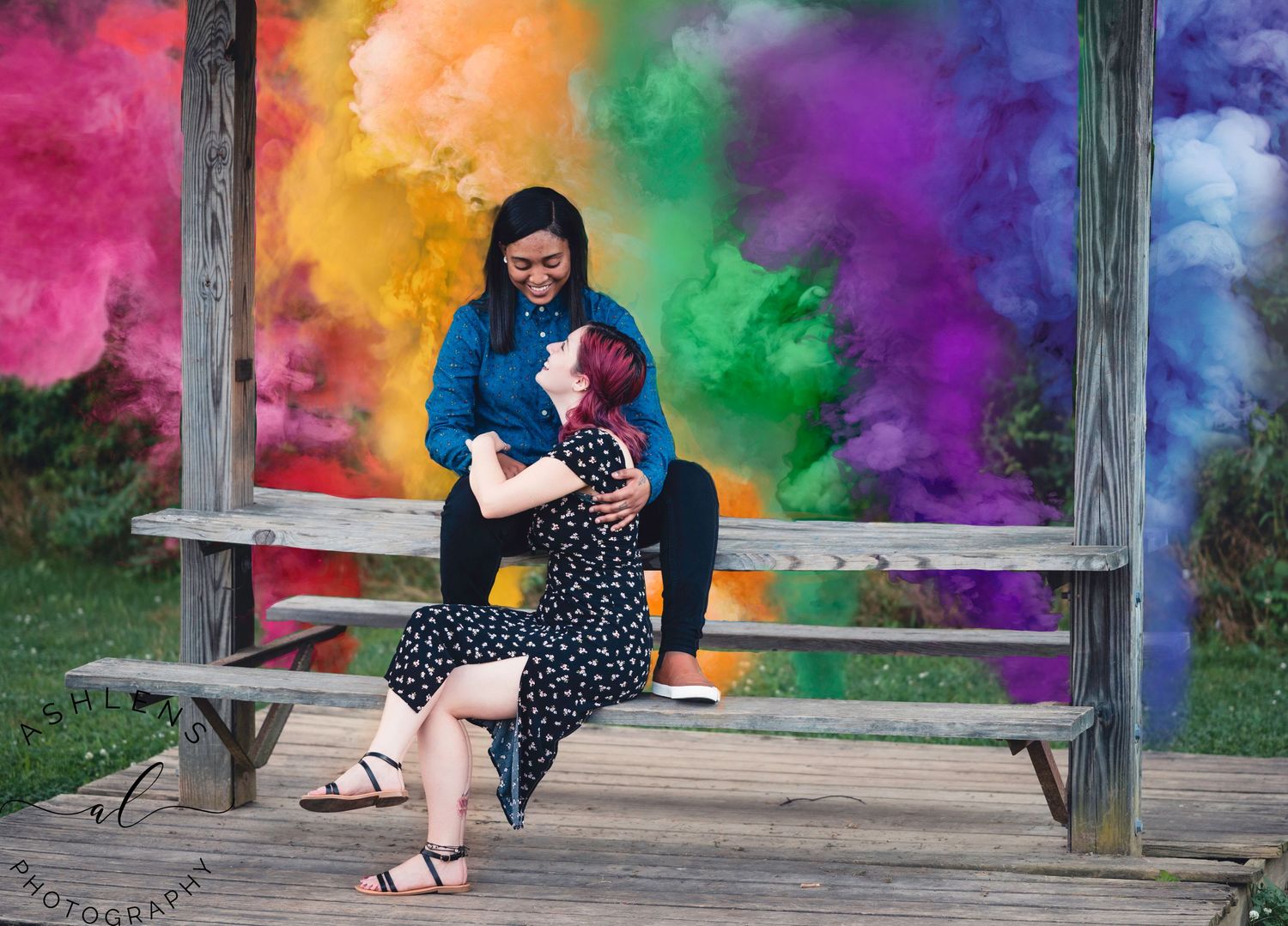 A colorful rainbow backdrop creates a vibrant setting for an outdoor portrait session.